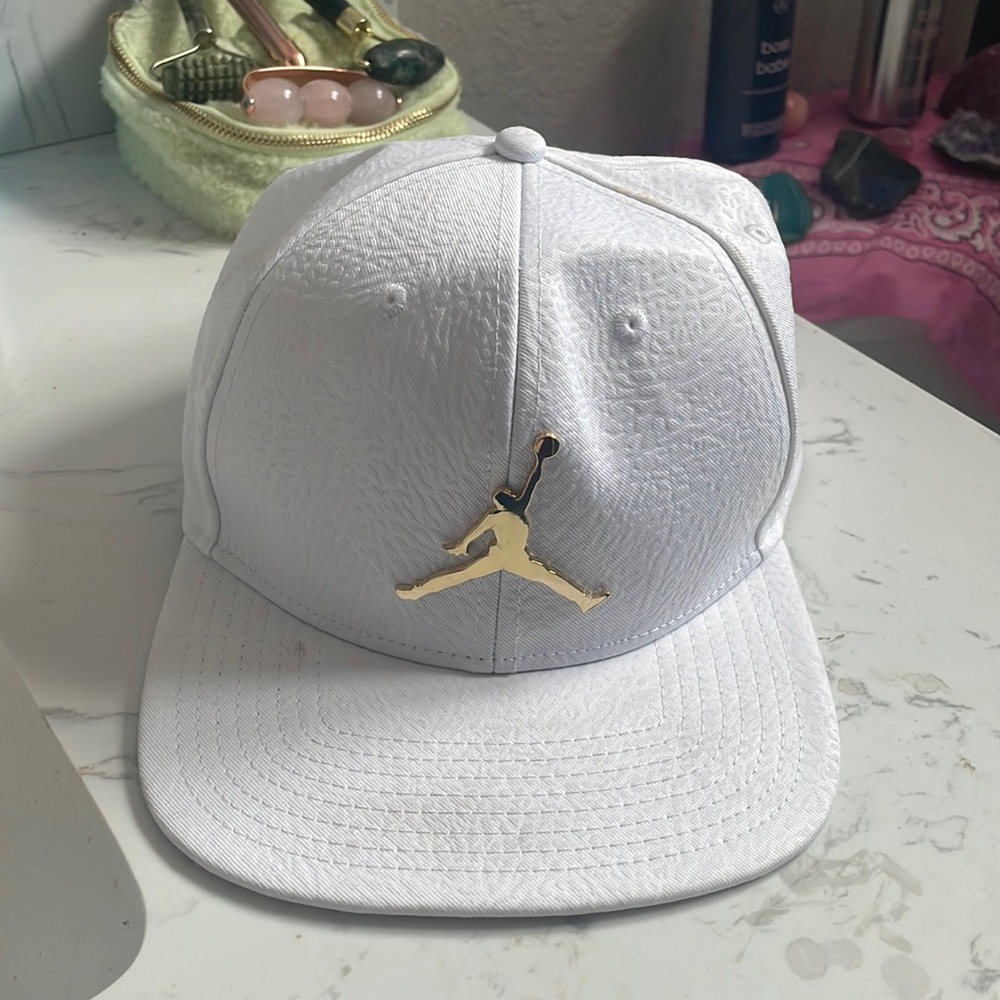 White hat with gold Jordan logo